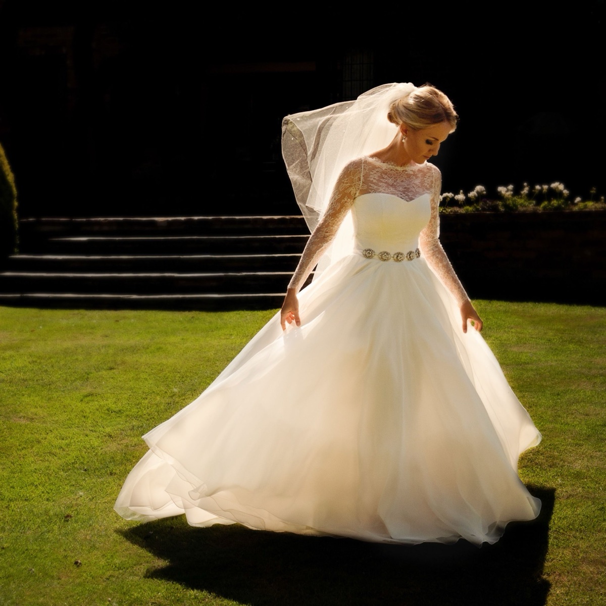Bride in her gown standing in sunlight