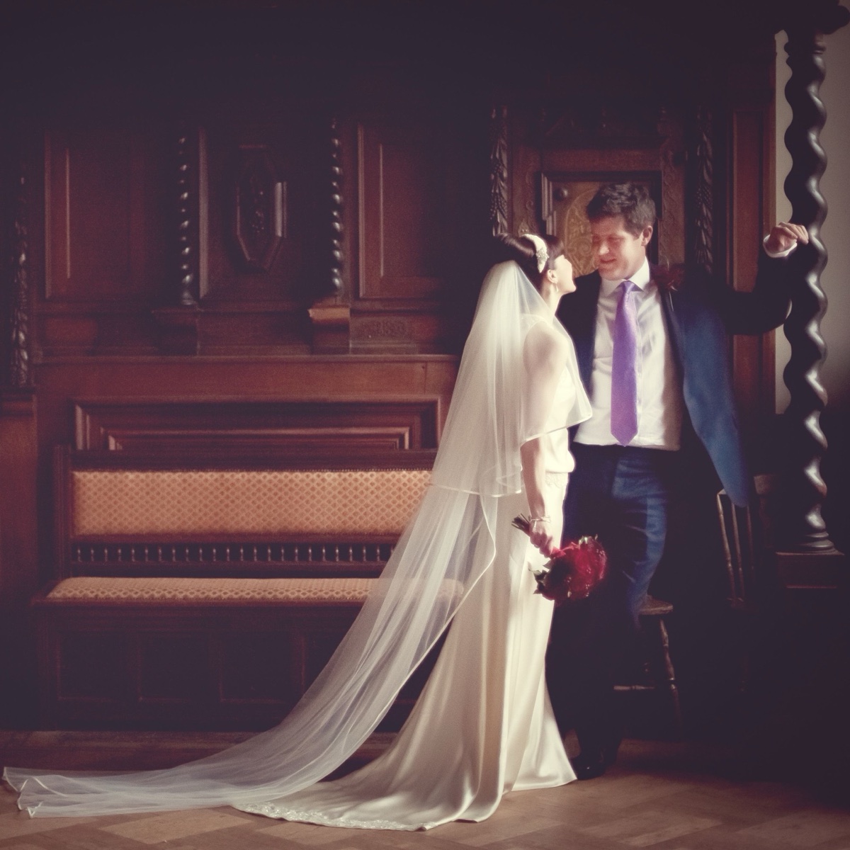 Bride and groom in natural window light at Hampton Court House