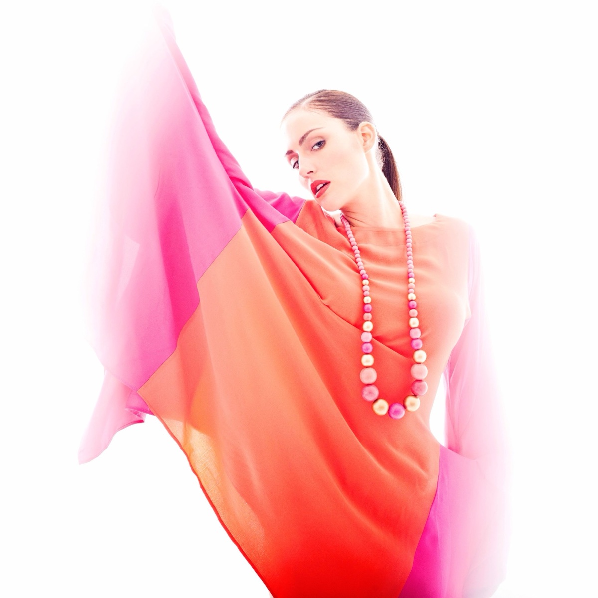 Colourful fashion portrait with flowing fabric