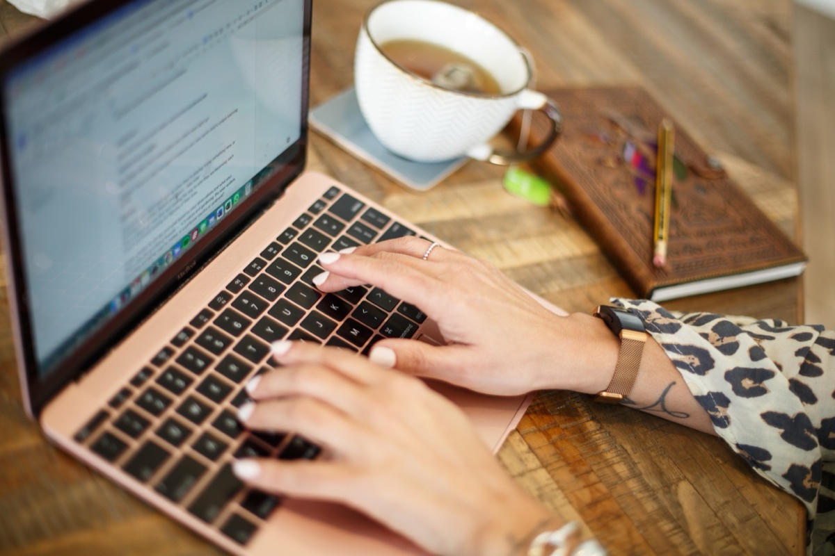 Entrepreneur working at a laptop with a cup of tea