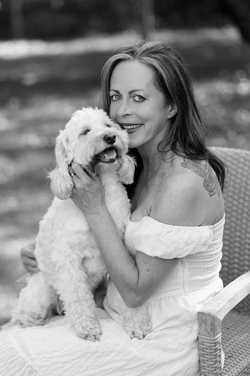 Black and white personal branding portrait with a dog