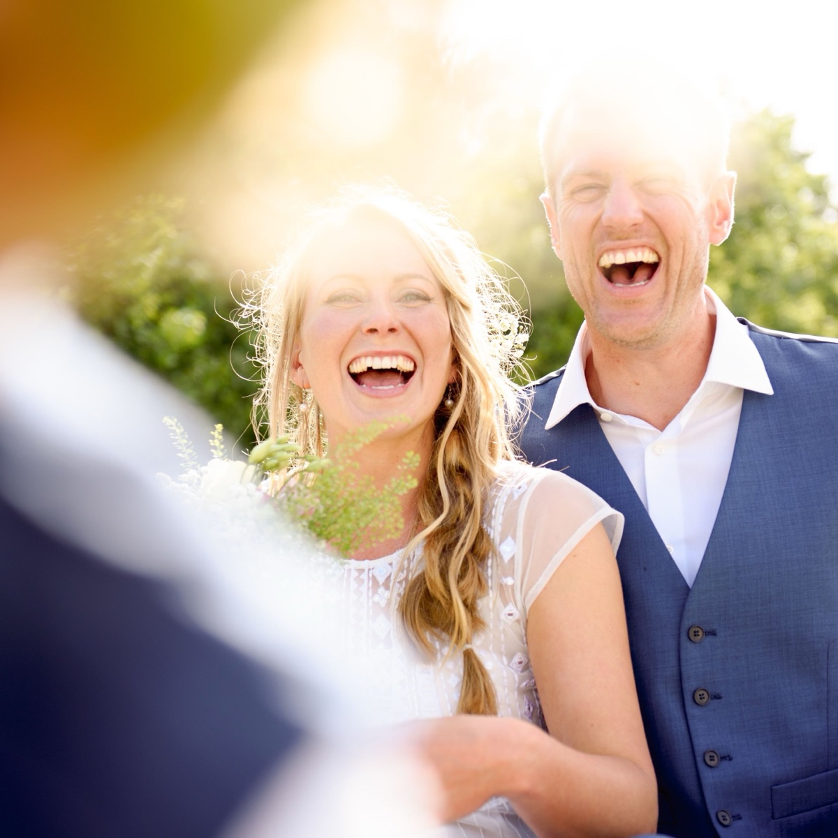 Couple laughing together on their wedding day
