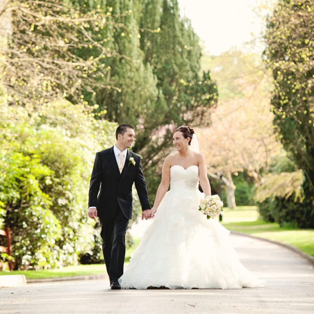 Bride and groom walking together outdoors